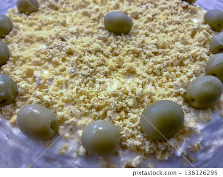 Russian salad presented on a ceramic plate and decorated with olives Russian salad presented on a ceramic plate and decorated with olives 136126295