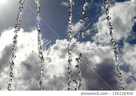 jets of water from a fountain with the sky in the background jets of water from a fountain with the sky in the background 136126408