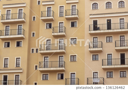 facade of a community with multiple balconies and windows of different sizes facade of a community with multiple balconies and windows of different sizes 136126462