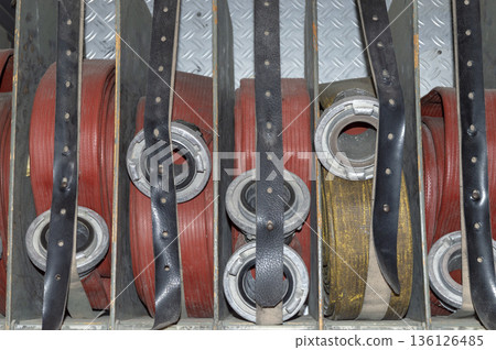 hoses rolled up and separated by departments on an old fire engine hoses rolled up and separated by departments on an old fire engine 136126485
