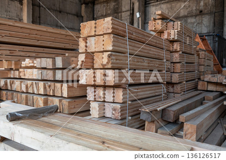 Stacked Wooden Beams and Planks in Warehouse Stacked Wooden Beams and Planks in Warehouse 136126517