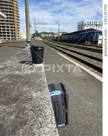 a suitcase on the rail station 136126709