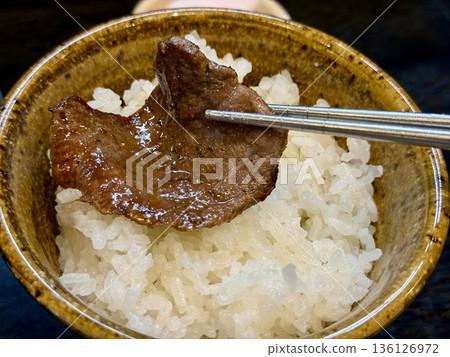 Grilling beef tongue at a yakiniku restaurant 136126972