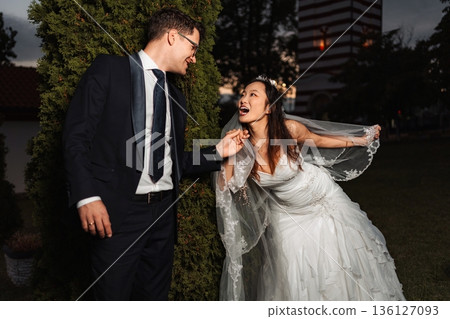 Interracial couple celebrating wedding day with joy Interracial couple celebrating wedding day with joy 136127093