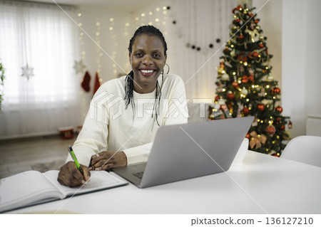 African American woman working from home during holidays African American woman working from home during holidays 136127210
