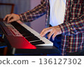 Musician at the Keyboard 136127302