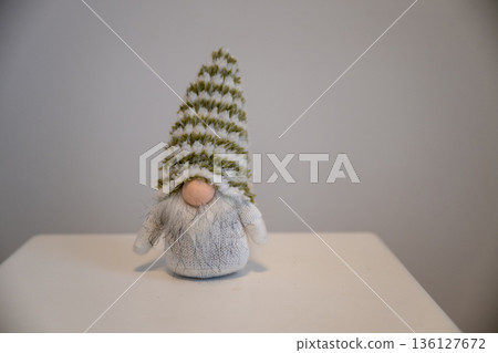 Christmas gnome decoration with striped hat on white table Christmas gnome decoration with striped hat on white table 136127672