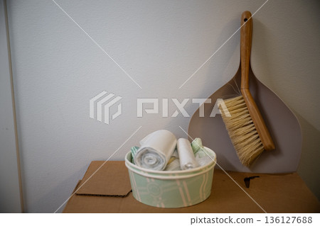 Minimal home still life with cleaning brush dustpan and reusable cloths on cardboard storage box 136127688