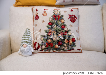 Festive Christmas pillow with decorated tree and cozy winter home interior decor Festive Christmas pillow with decorated tree and cozy winter home interior decor 136127692
