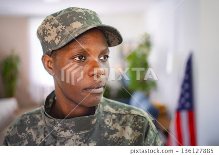 Confident african american female soldier wearing camouflage uniform indoors Confident african american female soldier wearing camouflage uniform indoors 136127885