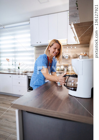 Female medical worker making coffee Female medical worker making coffee 136127921