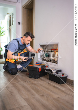 Plumber Inspecting Pipes and Taking Pictures with Smartphone Plumber Inspecting Pipes and Taking Pictures with Smartphone 136127965