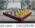 chessboard with golden and silver pieces isolated close-up 136128186