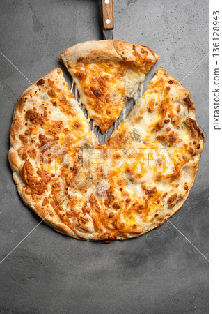 Cheese pizza with melted cheese 136128943