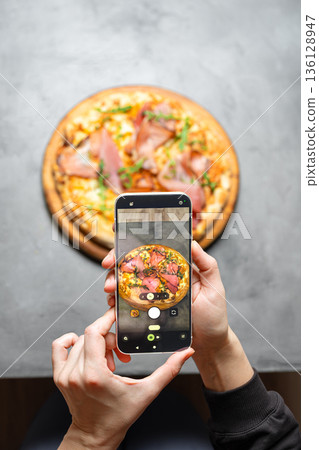 Taking photo of italian pizza by smartphone 136128947