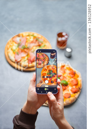 Taking photo of pizzas by smartphone 136128952