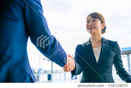 Business handshake to reach an agreement. Photo courtesy: Kansai International Airport (KIX) 136129035