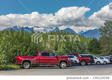 Cars parking in outdoor parking lot on sunny day. Cars parking in outdoor parking lot on sunny day. 136129299