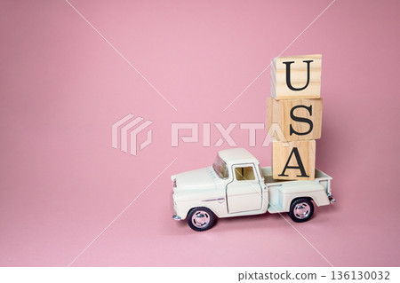 White truck is carrying blocks of wood and the letters USA White truck is carrying blocks of wood and the letters USA 136130032