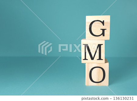 The image is a stack of wooden blocks with the letters GMO on top 136130231