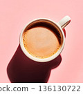 White coffee cup with a brown liquid in it 136130722