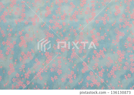 Cherry blossoms on handmade Mino washi paper that evokes the feeling of spring. Sky, clouds and cherry blossoms reflected on the water surface. 136130873