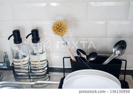 Authentic sustainability concept. Wooden brush for washing dishes in the kitchen. Eco friendly, zero waste or conscious consumption concept. Authentic sustainability concept. Wooden brush for washing dishes in the kitchen. Eco friendly, zero waste or conscious consumption concept. 136130898