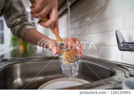 Zero waste concept. Eco-friendly kitchen wooden brush. Woman washing dishes with bamboo brush. Waste-free, eco-friendly concept Zero waste concept. Eco-friendly kitchen wooden brush. Woman washing dishes with bamboo brush. Waste-free, eco-friendly concept 136130901