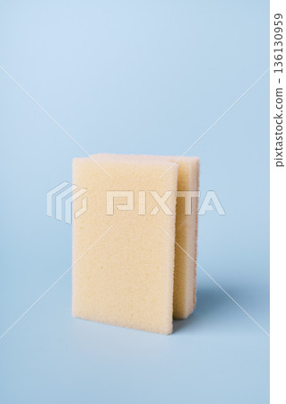Beige foam cleaning sponge used for household chores and sanitation 136130959