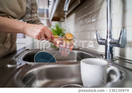 Zero waste concept. Eco-friendly kitchen wooden brush. Woman washing dishes with bamboo brush. Waste-free, eco-friendly concept Zero waste concept. Eco-friendly kitchen wooden brush. Woman washing dishes with bamboo brush. Waste-free, eco-friendly concept 136130974