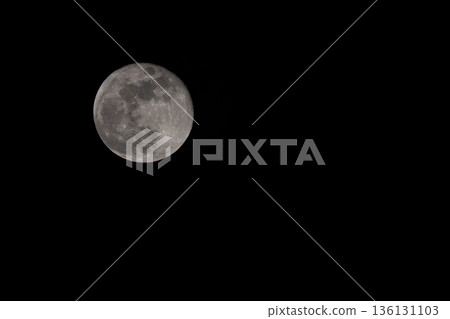 Full Moon on black background. Real photo of Full Moon over black night sky. Full Moon on black background. Real photo of Full Moon over black night sky. 136131103