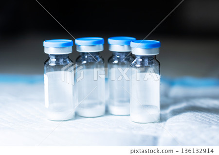 Vaccine vial inspection. Freezedried vaccine bottles displayed for safety assessment Vaccine vial inspection. Freezedried vaccine bottles displayed for safety assessment 136132914