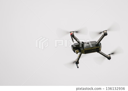 Drone flying over sky background 136132936