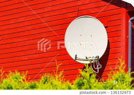Satellite dish on house wall 136132973