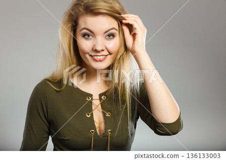 Attractive blonde woman wearing tight green khaki top 136133003