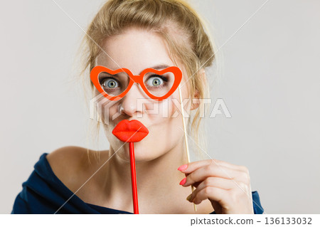 woman holds carnival accessories on stick woman holds carnival accessories on stick 136133032