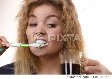 Funny woman being late drinking coffee Funny woman being late drinking coffee 136133045