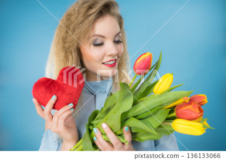 Woman holds tulips and red heart Woman holds tulips and red heart 136133066