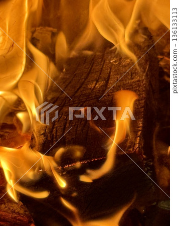 Close-up of burning firewood. Close-up of burning logs in fireplace. Close-up of burning firewood. Close-up of burning logs in fireplace. 136133113