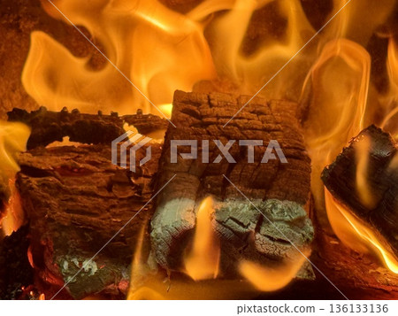 Close-up of burning firewood. Close-up of burning logs in fireplace. Close-up of burning firewood. Close-up of burning logs in fireplace. 136133136