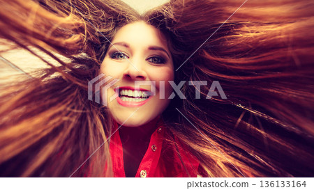Happy positive woman with long brown hair 136133164