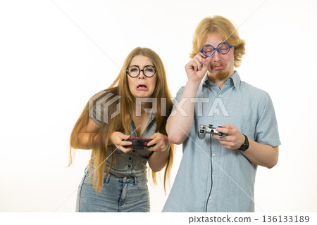 Gaming couple playing games and loosing Gaming couple playing games and loosing 136133189
