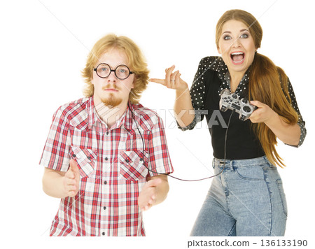 Woman controling man using gaming pad 136133190
