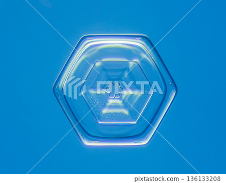 Natural snowflake crystal in blue background Natural snowflake crystal in blue background 136133208