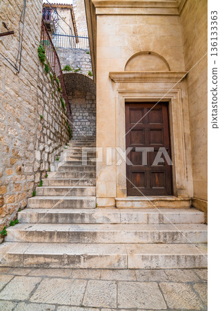 Narrow old town street at Sibenik city, Croatia. Famous tourist destination. Narrow old town street at Sibenik city, Croatia. Famous tourist destination. 136133363