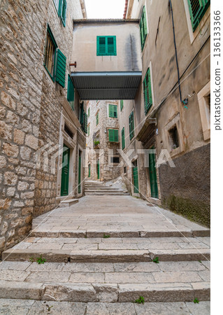 Narrow old town street at Sibenik city, Croatia. Famous tourist destination. 136133366