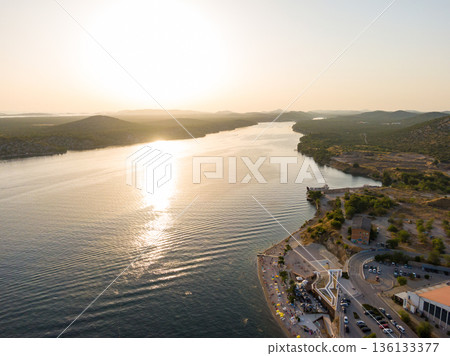 Aerial drone view of sunset over Kornati islands near the Sibenik city, Croatia. Water bay with boats ans soft sun light. 136133377