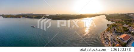 Aerial drone view of sunset over Kornati islands near the Sibenik city, Croatia. Water bay with boats ans soft sun light. 136133378