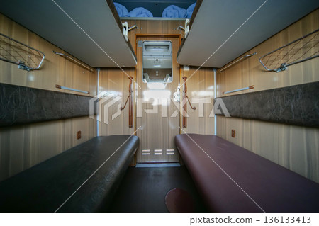 Train compartment providing a cozy cabin for passengers journeying by rail Train compartment providing a cozy cabin for passengers journeying by rail 136133413