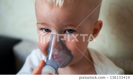 Little boy receiving nebulizer treatment for breathing illness, focusing on healthcare Little boy receiving nebulizer treatment for breathing illness, focusing on healthcare 136133419